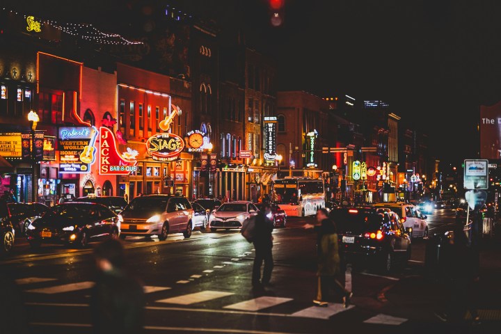 a street filled with traffic at night